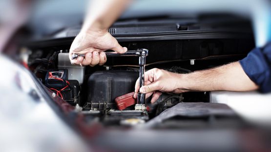 A mechanic securing the battery back down